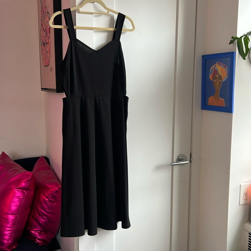Black dress with cute side cut outs. Very comfortable and chic. Size L. Good